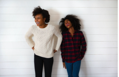 Two women are standing next to eachother, laughing, They may be friends. Therapy for mood disorders in Woodland Hills CA can help with coping with depression using cognitive behavioral therapy. 