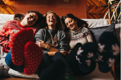 In this image, 3 girls are laying on a bed next to each other and raising their feet in the air. These three friends are wearing Christmas pajamas and are laughing and enjoying their time together. Reconnect with parts of your life that bring you joy other than your significant other. Individual and couples therapy can help you find a balance between your relationship and your life. 91364 | 91307 | 91356