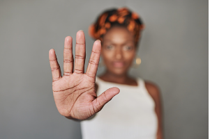 A girl points her hand towards the camera, signaling to raise awareness.