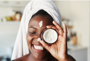Black woman holds a bottle of cream infront of her face which represents her showing care and time into her self care routine. 
    
    Anxiety therapy and counseling in Woodland Hills, CA can help you feel connected. Meet with an online marriage counselor in Woodland Hills, CA with online therapy in California here.  90077 | 91324 | 91364 | 91411 | 91436