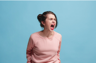 The background of this image is a baby blue color. In the middle we see a woman with her mouth open, yelling. Having difficulty managing your emotions is a sign of your mental health declining and being neglected. Virtual and in person therapy is offered at our Woodland Hills, CA therapy office. 91356 | 91301 | 91302