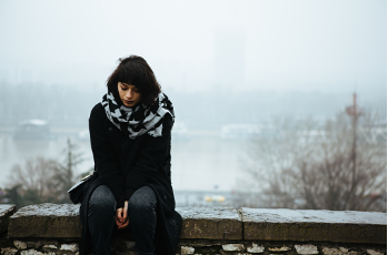 A woman is sitting outside in the snow, wearing a scarf, and looking downwards. A decline in mental health can show when you begin finding it difficult to seek help from others. Help is offered at our therapy clinic in Woodland Hills, CA via virtual or in person therapy sessions. 91356 | 91301 | 91302