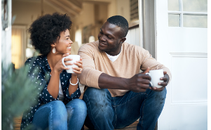 A man and woman are sitting on their porch with coffee cups in their hands, looking at one another, and smiling. Putting time aside to talk to your partner and hear their thoughts can help support your relationship in a healthier way. Couples therapy is available for in person and virtual sessions at our Woodland Hills, CA therapy practice.