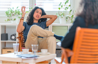 Teenage boy with long hair is seen sitting with his therapist with his leg over the other leg. Encouraging your teenager to go to therapy and share their troubles with a therapist can help them learn better coping mechanisms for their anxiety. Virtual and in person therapy is offered at our Woodland Hills therapy office. 91356 | 91301 | 91302\
        
        teen's anxiety