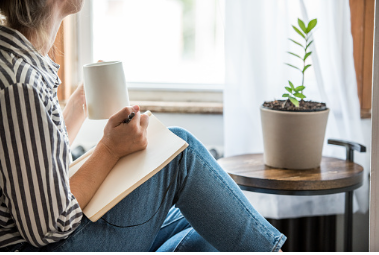 A young woman takes a break to do something analog like writing in her journal and drinking tea. This is a healthy practice for those who experience anxiety. Anxiety treatment in Los Angeles, CA can help with coping skills by talking to an anxiety therapist. 91356