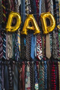 a bunch of ties and balloons with the word dad decorated on the wall