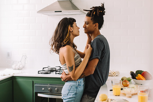 Beautiful young couple bonding in the kitchen. Cropped shot of an affectionate young couple embracing each other while standing together in their kitchen. Couple sharing a romantic moment at home. Therapy for couple's counseling in Woodland Hills CA can help with communication skills. 91307