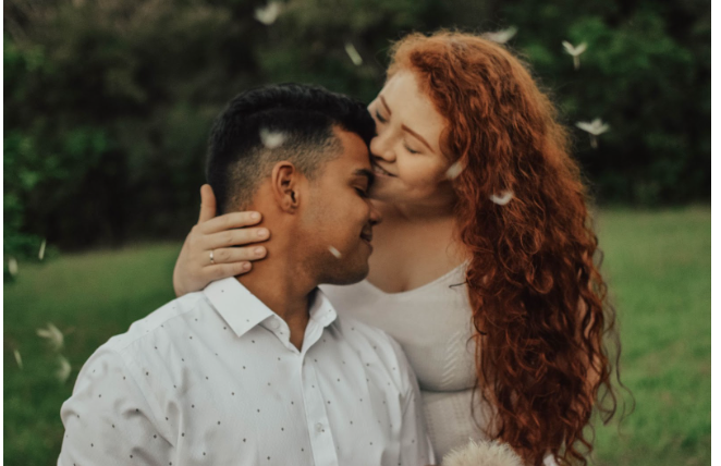Couple kissing in a field. Feeling joy after couples therapy and marriage counseling in Los Angeles, CA with a marriage counselor via online therapy can help you! 91364 | 91307 | 91356 | 91301 | 91302 | 91372I 91367 