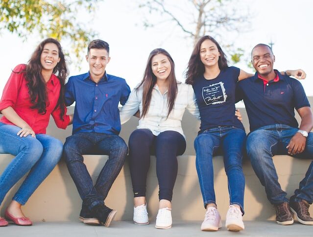 This image may depict a group of teenagers or young adults hanging out and enjoying each other's company. Embracing You Therapy offers group and individual therapy for adults and teens.