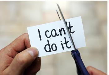Someone holds a pair of scissors and a piece of paper with the words I can't do it. he is cutting the t, transforming it into I can do it.
