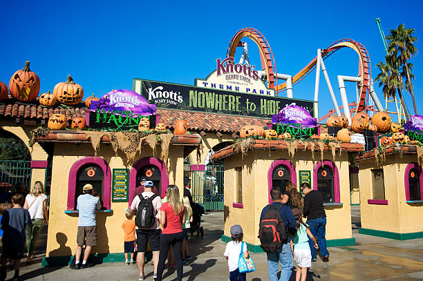 In this image we see the front entrance to Knott's Scary Farm. There are multiple families entering the park together.