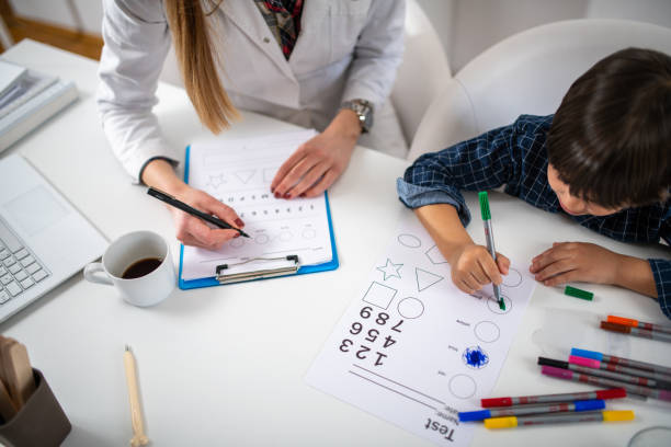 Toddler in a psychology test through coloring shapes, fostering early cognitive development