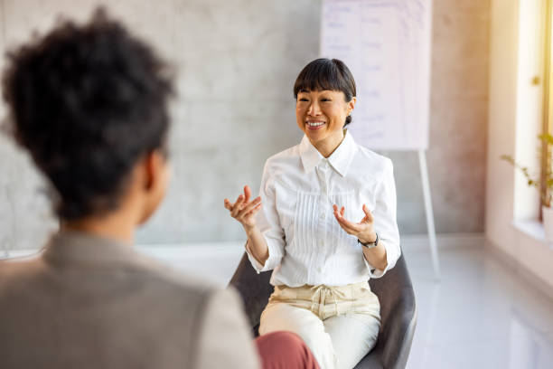 Shot of a young woman having a therapeutic session with a psychologist