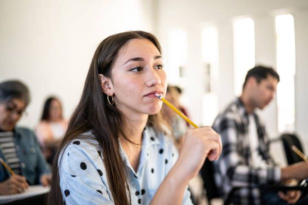 Young woman thinking while watch class at university